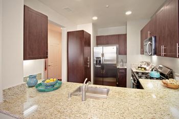 A kitchen with stainless steel appliances and granite counter tops